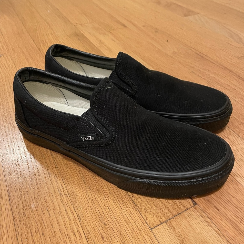 Black on black classic Vans slip ons